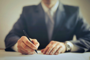 A businessman signing papers 