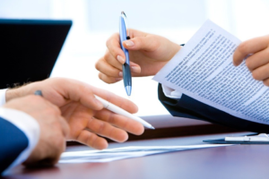 Professionals discussing documents before signing 