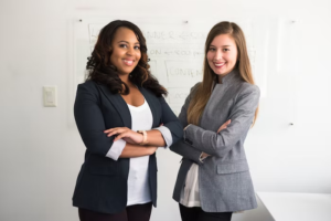 two tax advisors standing with their arms crossed