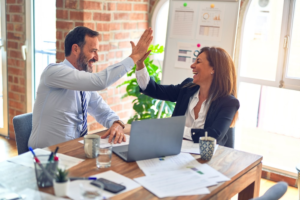 a man and woman high-fiving 