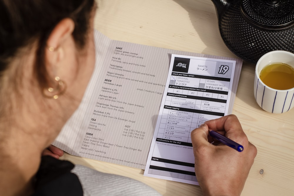 A person filling out business permit forms