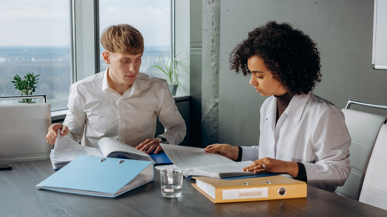 Two colleagues reviewing files