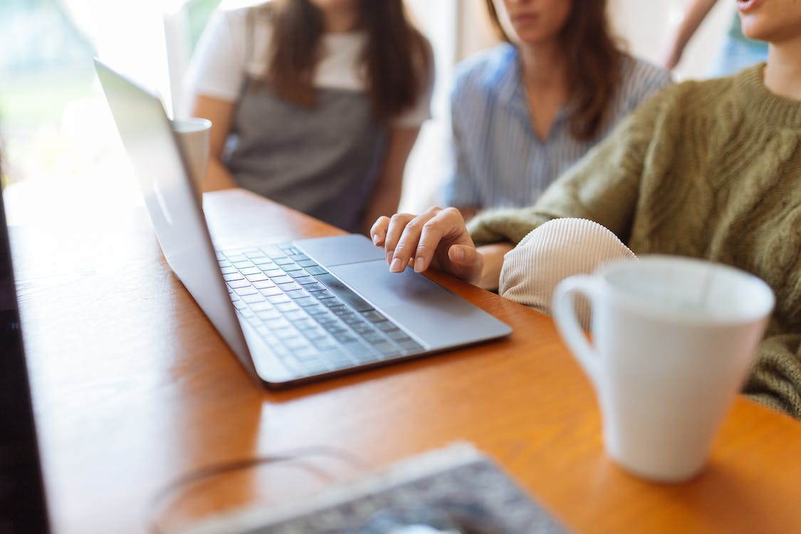 Three colleagues working on a laptop