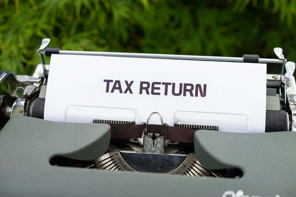 a typewriter with a document stating ‘tax return’