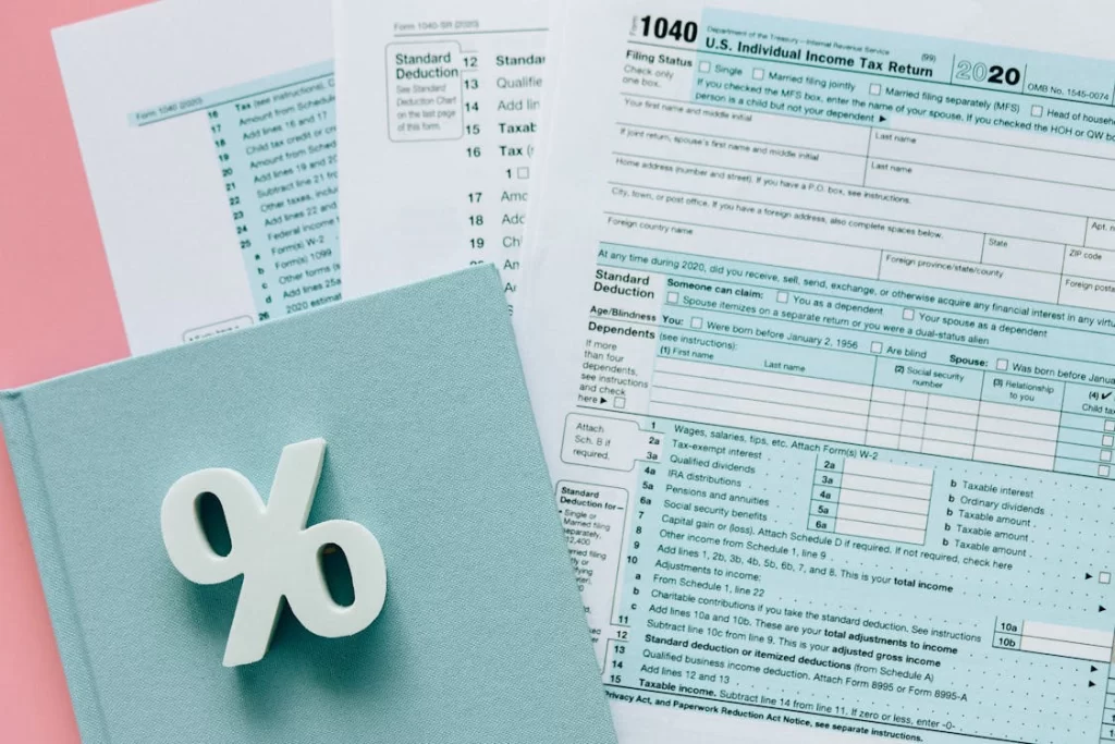 a bunch of financial documents scattered on a pink surface