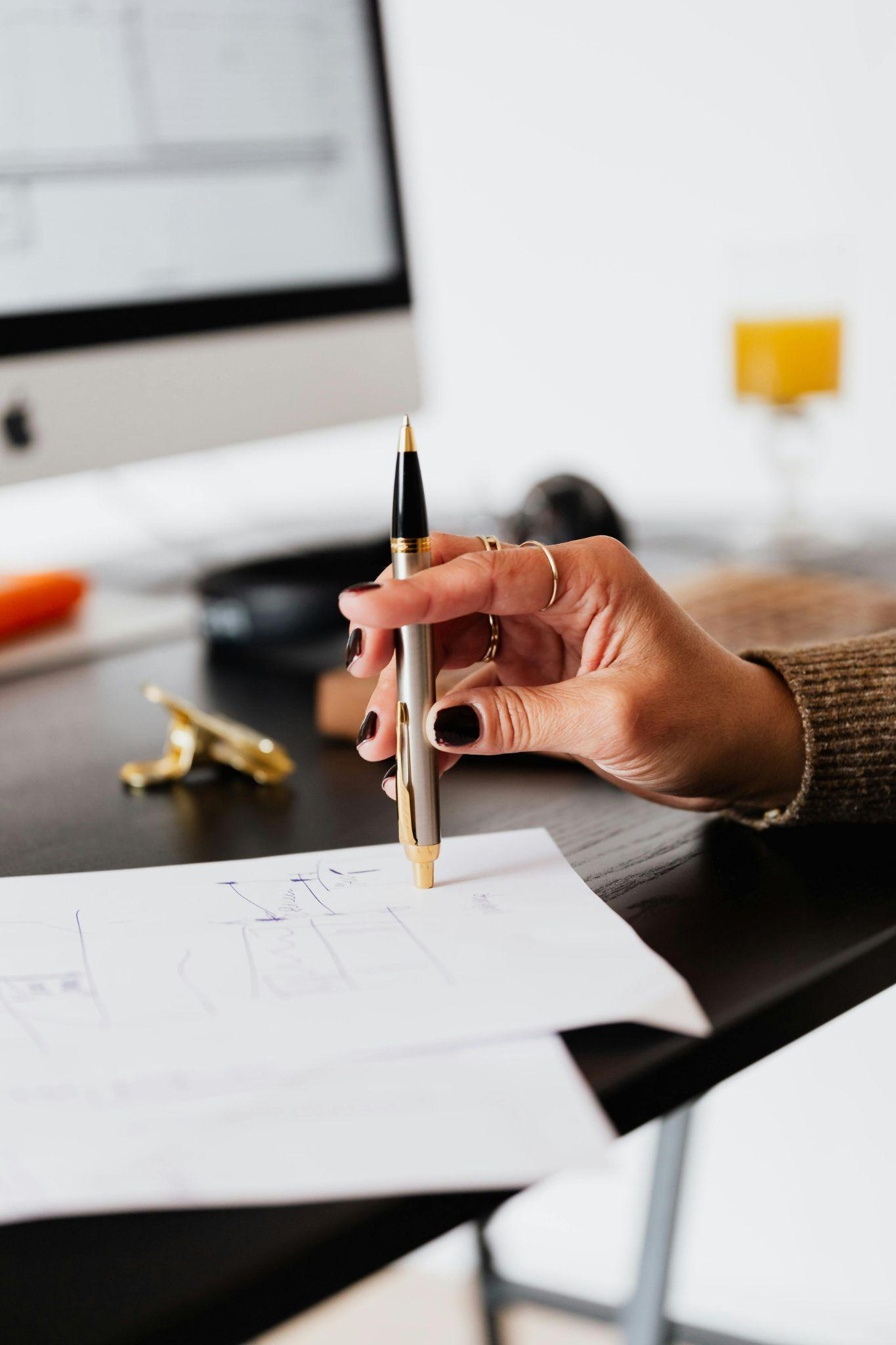 A woman holding a pen