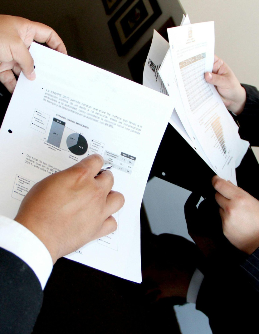 Two people holding documents