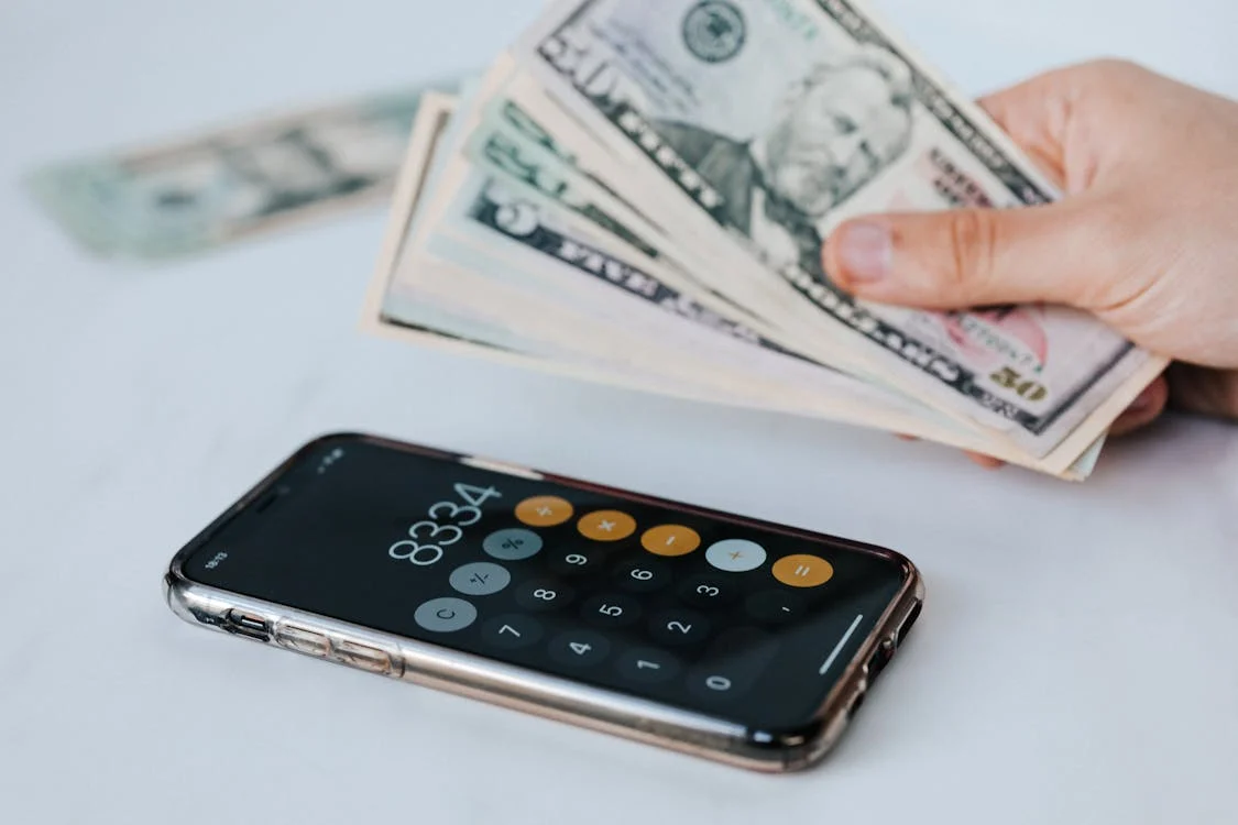 a person holding a bundle of cash