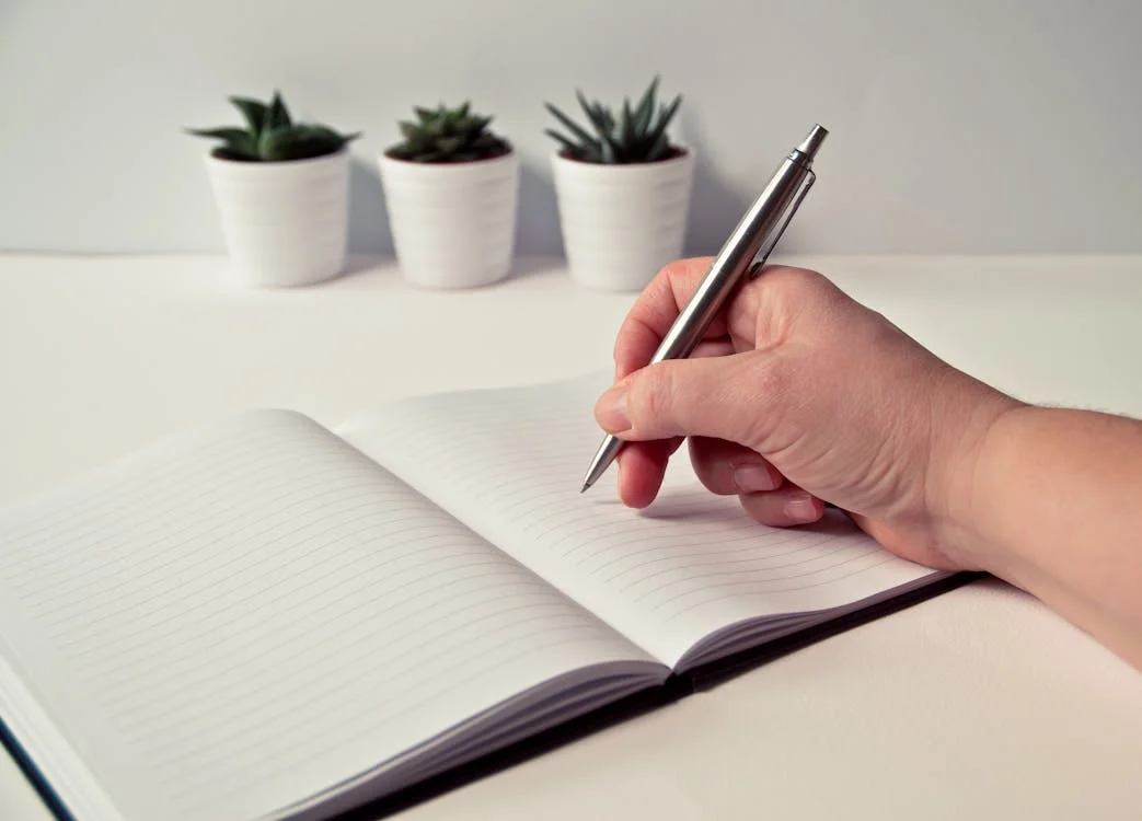 a person writing in their notebook