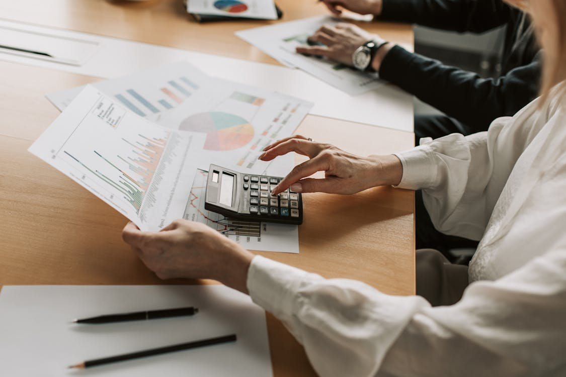 a woman going through graphs and calculating