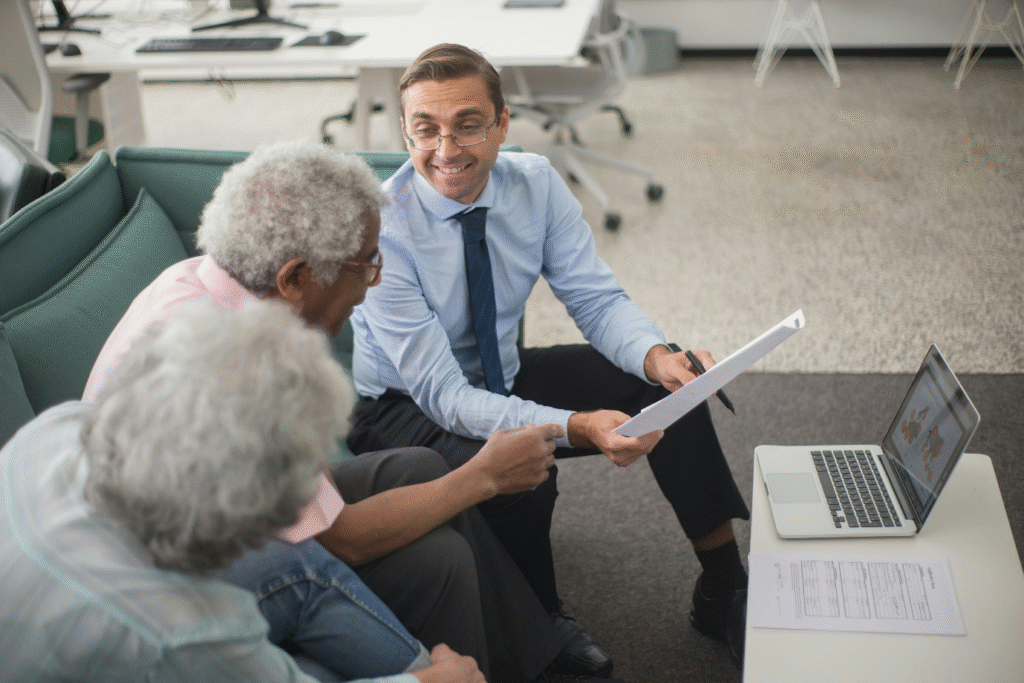 photo showing a person showing a document to two elderly people