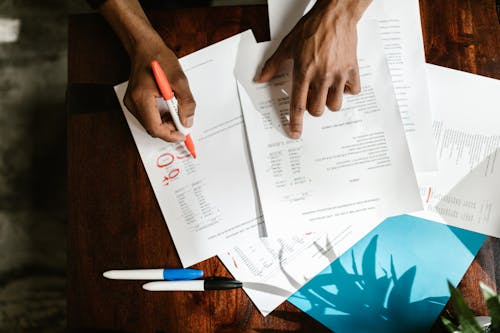 a person marking AR and AP on paperwork