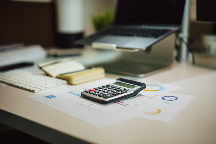 This photo shows a calculator on top of some documents.